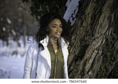 Snow against close up of a beautiful young black woman