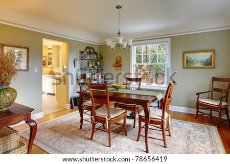 Green dining room with mahogany furniture