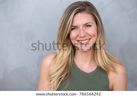 Cute natural blonde woman smiling with perfect white teeth and glowing skin