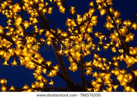 This is a picture of decorative lights of a festive season  lighting tree
Christmas lights border. Glowing colorful Christmas lights on black background. New Year. Christmas. Decor. Garland.
