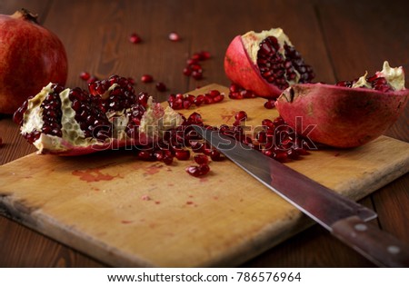 cut pomegranate fruit knife table board