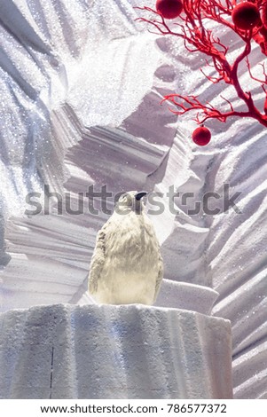 White decorative penguin among the ice