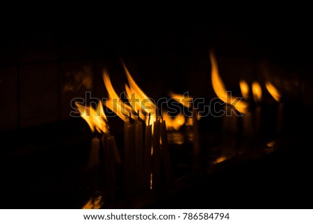 Church Candles Burning in Dark