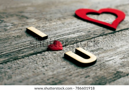 red heart, word with wooden letters, love, I love you on a wooden background