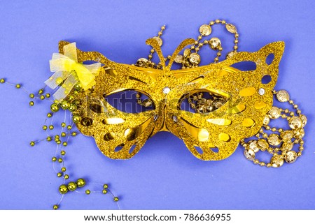 Mardi Gras Festival. Luxurious masquerade Venetian carnival mask on purple background. Studio Photo