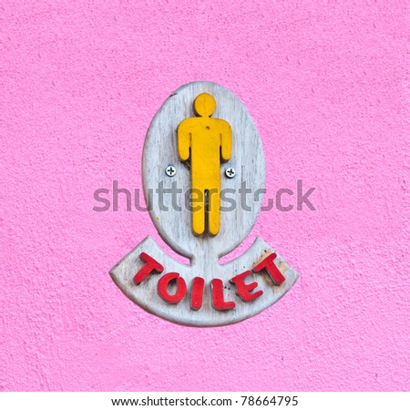 Men toilet sign on pink wall
