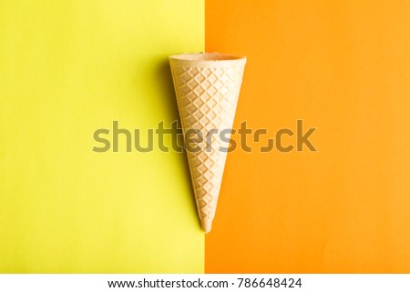 Ice cream cone on double colorful background.