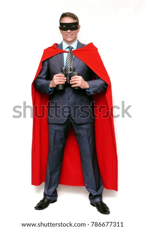 Happy super hero man holds in hands a binoculars isolated on white background.