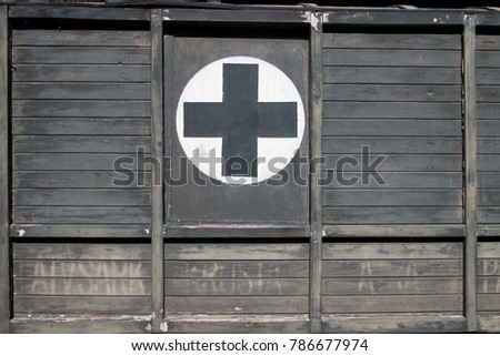 Firts Aid Black Cross on Wood on Old Retro Ambulance Car