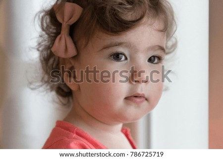 little beautiful girl with a bow. horizontal Close-up portrait