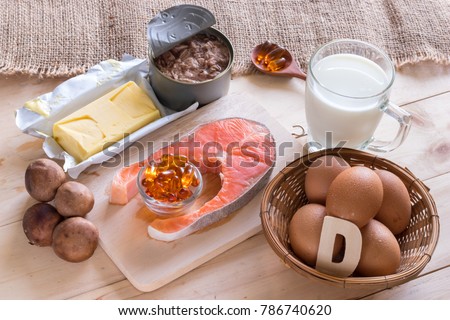 Natural source of vitamin D in Salmon, eggs, mushroom, fortified milk, margarine, canned tuna and fish oil capsule on wooden texture and background, healthcare and supplemental concept Royalty-Free Stock Photo #786740620
