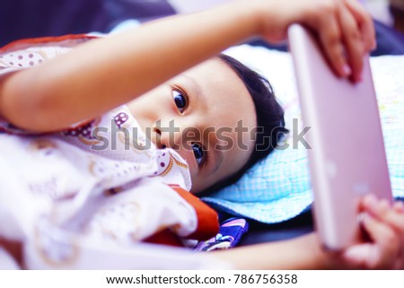 Asian Boy Playing Smartphone. Kids Watching Smartphone And Play Game. Kids Addicted To Game And Cartoon
