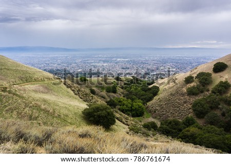 Hills and valleys in Alum Rock Park on a rainy day; San Jose, California in the background