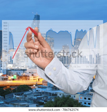 Ideas of Business Profits,hands of a business man use a red pen pointing to the top of the red arrow.