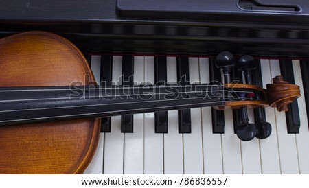 Violin isolated on piano background