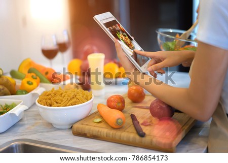 couple lover help o each other cooking online, learning cooking from website internet for a new married couple home Royalty-Free Stock Photo #786854173