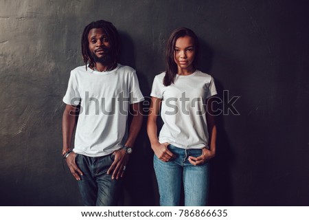 Beautiful African American couple in white t-shirts. Mock-up. Royalty-Free Stock Photo #786866635