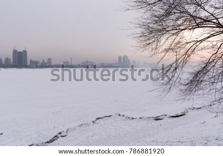 Beautiful landscape of Harbin city with frozen Songhua River in the sunset. It's landmark and popular for tourist attractions in Harbin. Heilongjiang. China. Asia.
