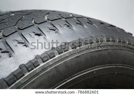 Old, damaged and worn black tire tread. Change time. Tire tread problems and solutions concept. Royalty-Free Stock Photo #786882601