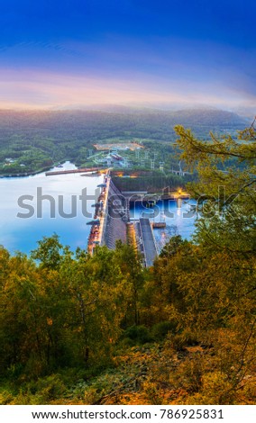 Hydroelectric power station on the Yenisei River in Siberia near Krasnoyarsk in the glow of the sunrise