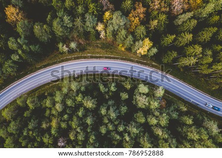Aerial view of car driving through the forest on country road. Kaunas county, Lithuania Royalty-Free Stock Photo #786952888