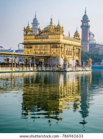 Golden Temple, Sikh Gudwara in Amritsar, India. 
Reflections on sacred pond of Harmandir Sahib, holiest shrine of the Sikh religion. Famous Indian landmark on sunny day.

 Royalty-Free Stock Photo #786961633