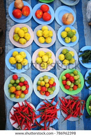Lemon, tomatoes and chili on plate in the street market.