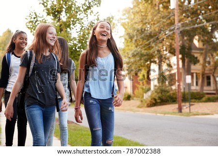 Four young teen girls walking to school, front view close up Royalty-Free Stock Photo #787002388
