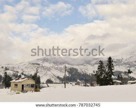ski resort on the quite day with a little of blue sky and mountain covered by snow in in Japan