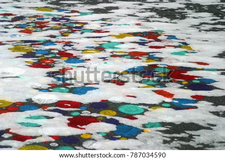 Bright pictures, circles on the asphalt covered with white snow. Winter holiday background