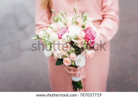 Woman with bouquet of flowers, close up. 