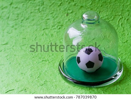 soccer ball under the glass dome. football game with copy space.