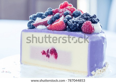 Tasty Ice-cream cake with fresh berries on a glass plate. Light background. Shallow depth of field