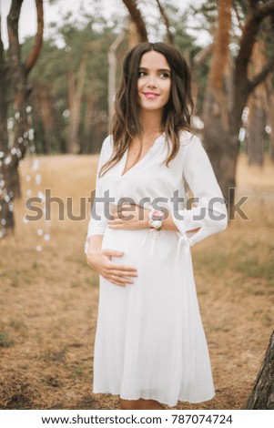 Beautiful pregnant girl in the park