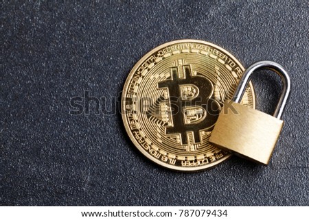 bitcoin security concept. Gold coin with padlock Royalty-Free Stock Photo #787079434