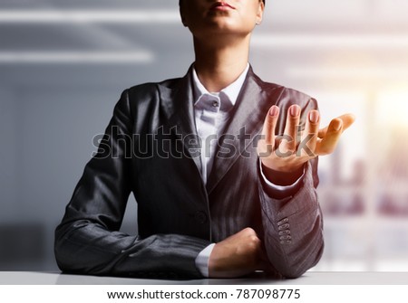 Cropped image of businessman in black suit presenting empty palm with office view and sunlight on background. 3D rendering.