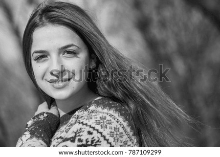 black and white picture of beautiful young smiling woman outside in the winter