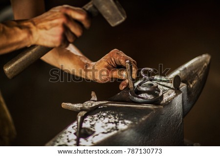 About artistic Forging of Metal. Blacksmithing.
Pattern and forms for the artist blacksmith.
Treatment of molten metal close-up. Handmade blacksmith. Royalty-Free Stock Photo #787130773