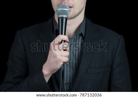 Close up of a man wearing suit holding microphone - public speaking, conference, reportage