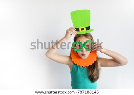 The cute girl in a mask of a leprechaun for a St. Patrick's Day Royalty-Free Stock Photo #787188145