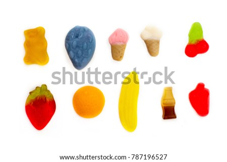 Multi-colored bright assortment of jellies in different shapes on white background