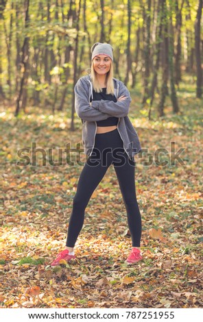 A portrait of happy young attractive girl in an autumn park
