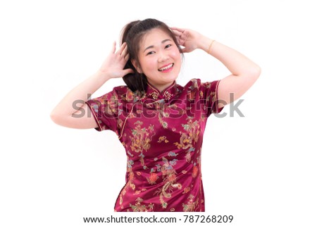 Young asian woman wearing chinese dress traditional cheongsam with gesture of congratulation, Looking at the camera and smile in Chinese New Year Festivities, New Year Celebration on white background.