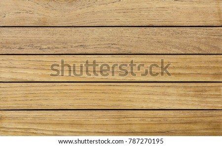 Overhead view of a table top made of natural teak wooden batten.