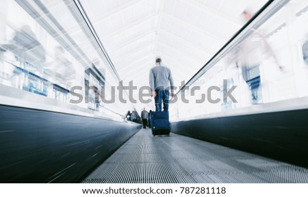 blurred business commuters using staircases on a airport