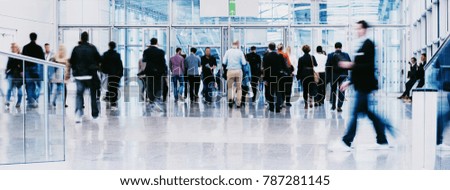 large crowd of anonymous blurred business people at a trade fair