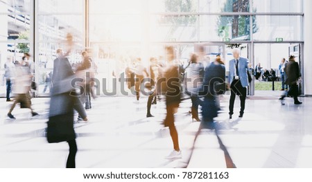 crowd of anonymous blurred people at a trade fair corridor
