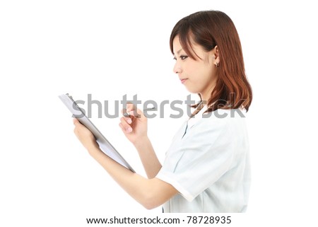 Young japanese female nurse in uniform, holding a clipboard
