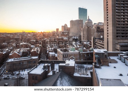 Rooftops across the city of Boston Massachusetts at sunset