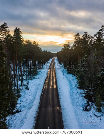 Aerial Photo of Snowy Road Between Trees, Winter Evening in Sunset Colors